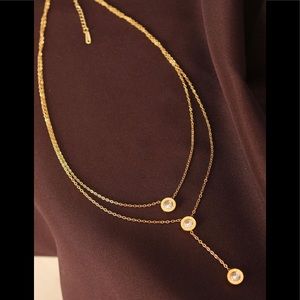 Women's gold steel necklace with zircon gemstones.